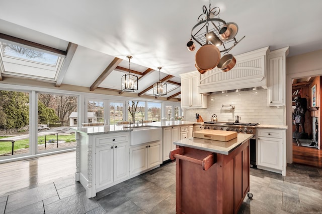 77 Eastfield Rd, Waterbury, CT 06708 - kitchen with backsplash, a peninsula, plenty of natural light, and a sink