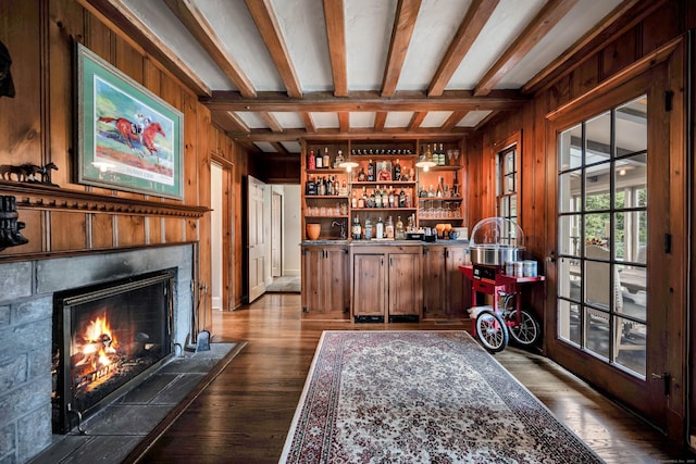77 Eastfield Rd, Waterbury, CT 06708 - bar featuring wood walls, a fireplace, beam ceiling, a bar, and dark wood-style floors