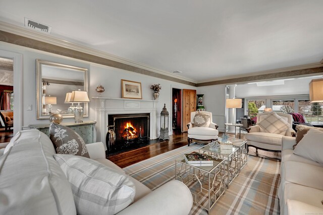 77 Eastfield Rd, Waterbury, CT 06708 - living room featuring ornamental molding, visible vents, a fireplace with flush hearth, and wood finished floors