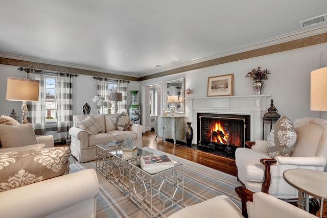77 Eastfield Rd, Waterbury, CT 06708 - living room with visible vents, wood finished floors, ornamental molding, and a fireplace with flush hearth