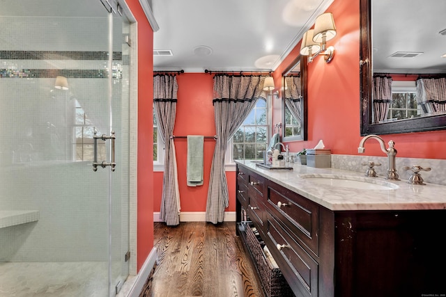 77 Eastfield Rd, Waterbury, CT 06708 - full bath with vanity, a stall shower, visible vents, ornamental molding, and wood finished floors