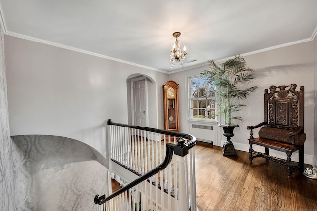 77 Eastfield Rd, Waterbury, CT 06708 - living area featuring radiator, an upstairs landing, a notable chandelier, arched walkways, and wood finished floors