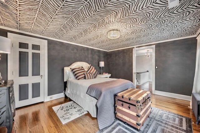 77 Eastfield Rd, Waterbury, CT 06708 - bedroom with a notable chandelier, an ornate ceiling, baseboards, ornamental molding, and hardwood / wood-style flooring