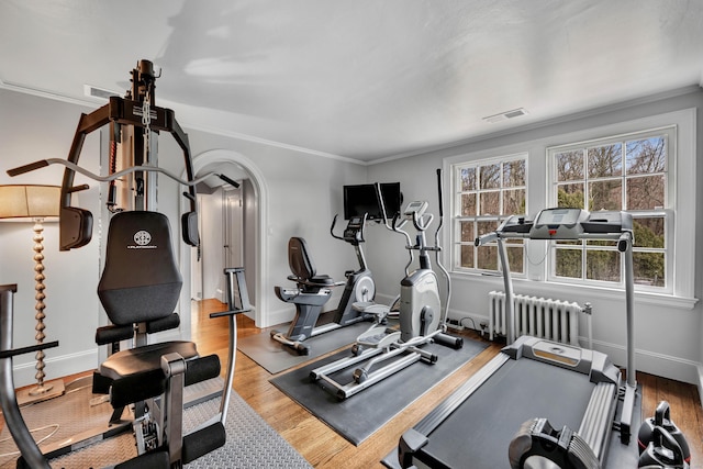 77 Eastfield Rd, Waterbury, CT 06708 - workout area featuring wood finished floors, radiator, ornamental molding, baseboards, and visible vents