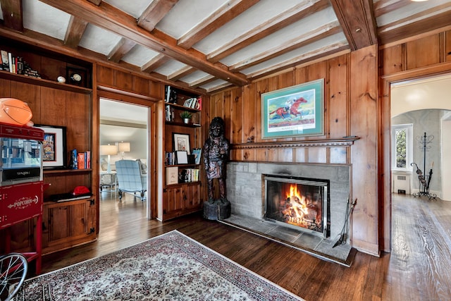 77 Eastfield Rd, Waterbury, CT 06708 - interior space featuring dark wood-style floors, a tile fireplace, wood walls, and beam ceiling