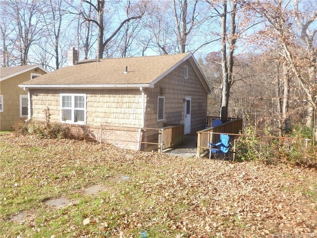 197 Lee Farm Dr, Southbury, CT 06488 - back of property featuring a chimney, a shingled roof, and fence