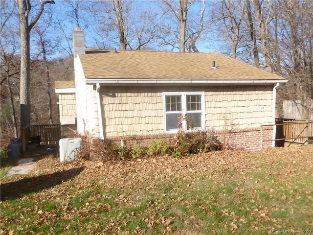 197 Lee Farm Dr, Southbury, CT 06488 - view of side of property featuring roof with shingles and a chimney