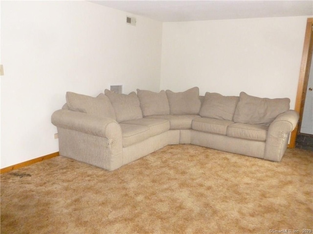 unfurnished living room featuring visible vents, baseboards, and carpet flooring