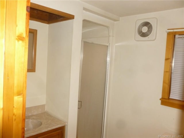 bathroom featuring visible vents, a shower stall, and vanity