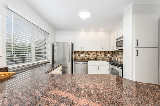 199 Gregory Blvd Apt F1, Norwalk, CT 06855 - kitchen featuring stainless steel appliances, a sink, decorative backsplash, white cabinets, and dark stone countertops