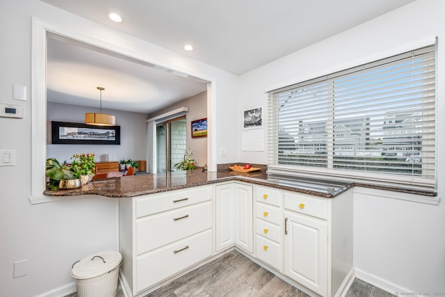 199 Gregory Blvd Apt F1, Norwalk, CT 06855 - kitchen with white cabinets, dark stone countertops, decorative light fixtures, light wood finished floors, and recessed lighting