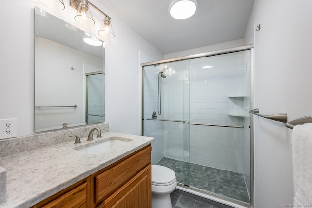 199 Gregory Blvd Apt F1, Norwalk, CT 06855 - bathroom featuring a stall shower, toilet, vanity, and tile patterned flooring