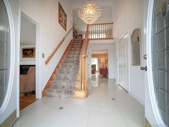 10 Edgehill Dr, Woodbridge, CT 06525 - foyer entrance featuring stairway, a towering ceiling, a chandelier, tile patterned floors, and baseboards