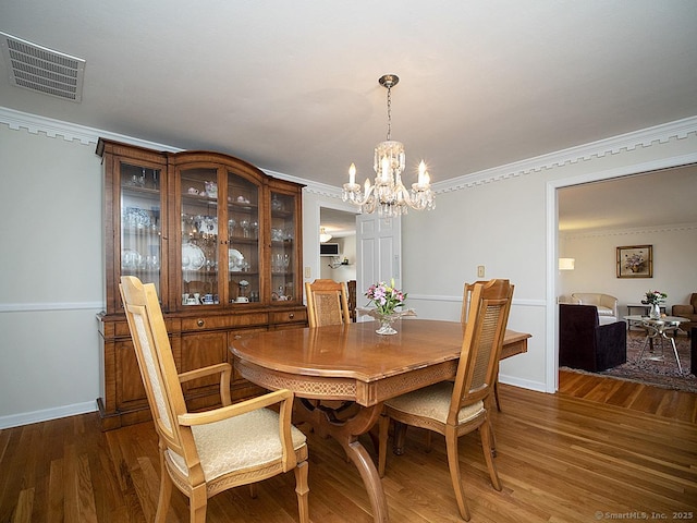 10 Edgehill Dr, Woodbridge, CT 06525 - dining area featuring a chandelier, wood finished floors, crown molding, and baseboards