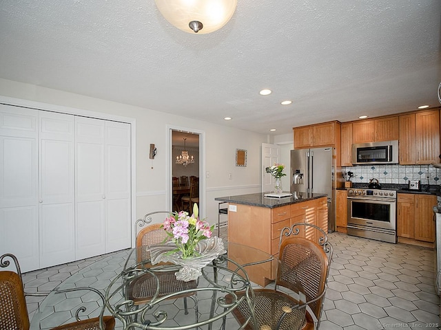 10 Edgehill Dr, Woodbridge, CT 06525 - kitchen featuring stainless steel appliances, a kitchen island, decorative backsplash, recessed lighting, and brown cabinetry
