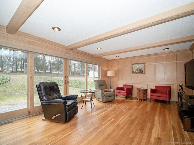 10 Edgehill Dr, Woodbridge, CT 06525 - living area featuring beamed ceiling, light wood-style floors, a decorative wall, and plenty of natural light