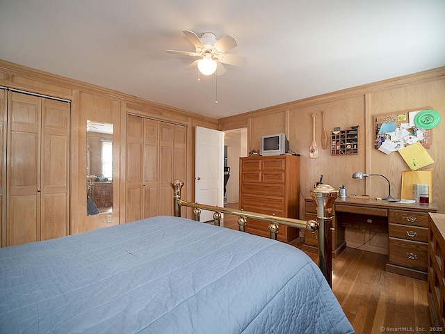 10 Edgehill Dr, Woodbridge, CT 06525 - bedroom with wood finished floors, multiple closets, ceiling fan, and wood walls