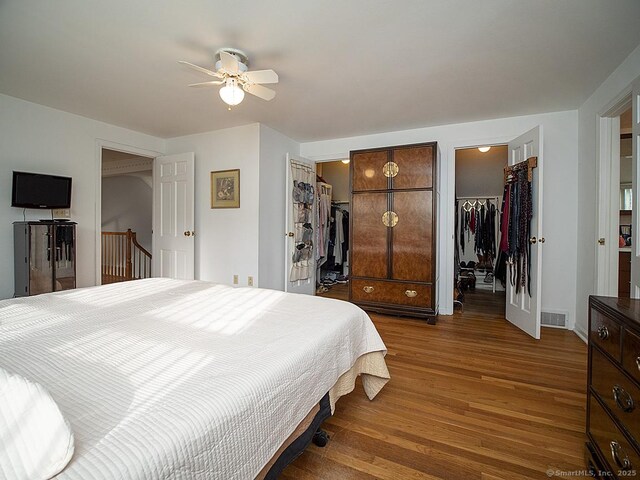 10 Edgehill Dr, Woodbridge, CT 06525 - bedroom with a walk in closet, wood finished floors, a ceiling fan, and a closet