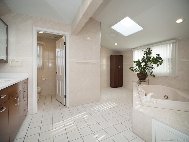 10 Edgehill Dr, Woodbridge, CT 06525 - bathroom featuring tile walls, a whirlpool tub, tile patterned flooring, vanity, and toilet