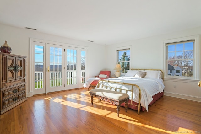 7 Long Meadow Ln, Redding, CT 06896 - bedroom featuring access to outside, baseboards, wood finished floors, and visible vents