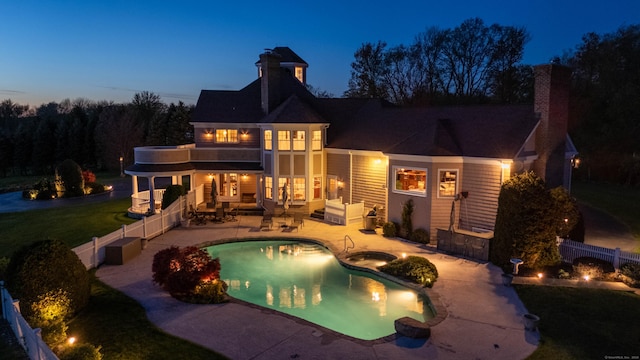7 Long Meadow Ln, Redding, CT 06896 - rear view of house with a patio, a chimney, a balcony, and a fenced backyard