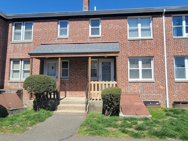 multi unit property with brick siding and covered porch