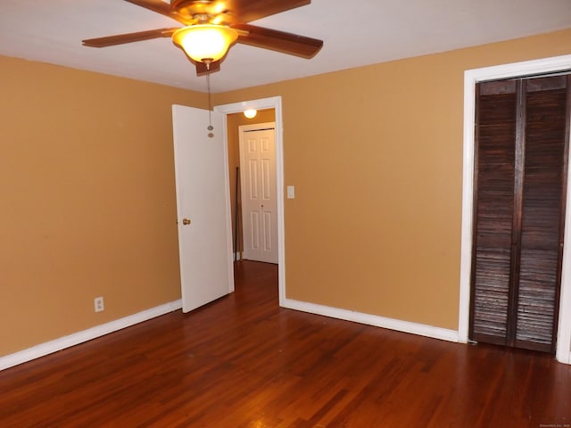 unfurnished bedroom with wood finished floors, baseboards, and ceiling fan