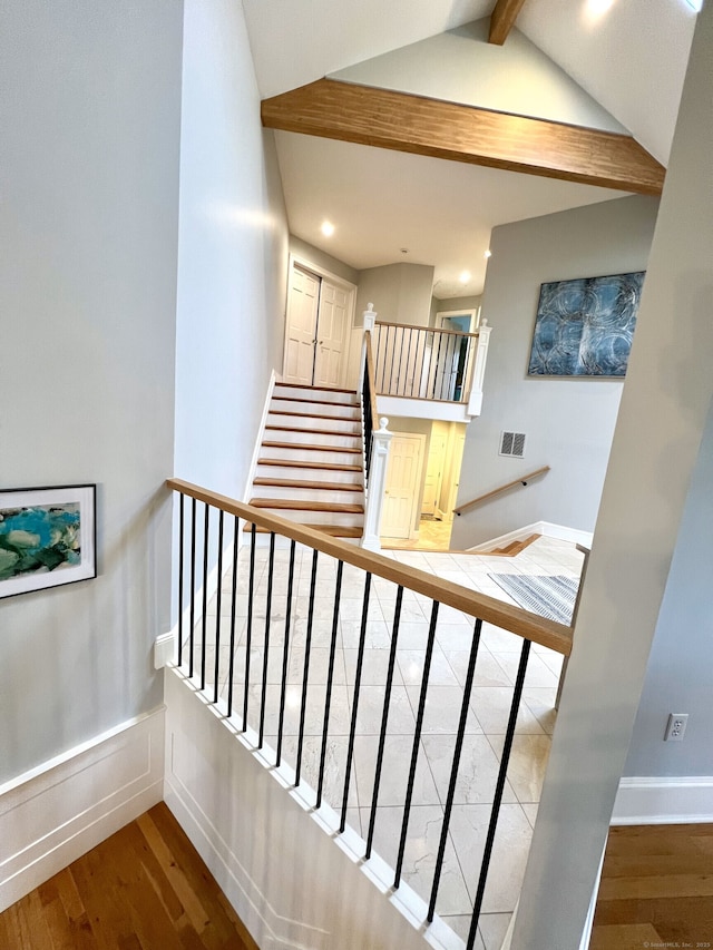 stairs featuring vaulted ceiling with beams, visible vents, recessed lighting, baseboards, and wood finished floors