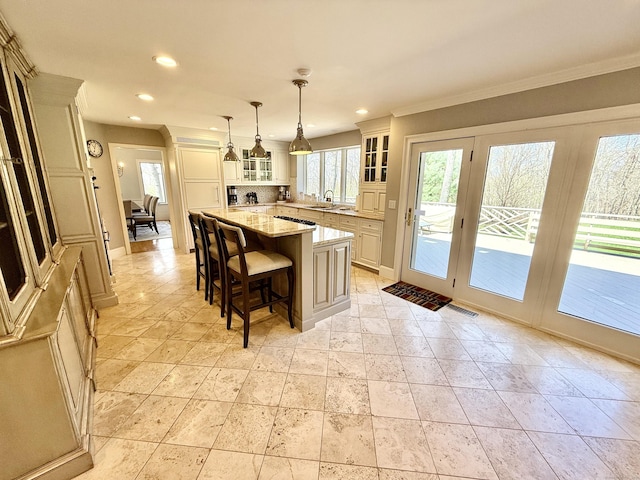 kitchen featuring a center island, a sink, visible vents, and recessed lighting