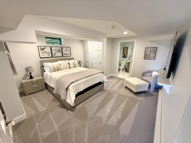 carpeted bedroom featuring recessed lighting, ensuite bath, and baseboards