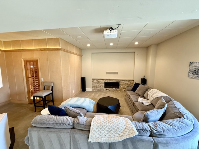 carpeted living area with baseboards, a drop ceiling, and recessed lighting