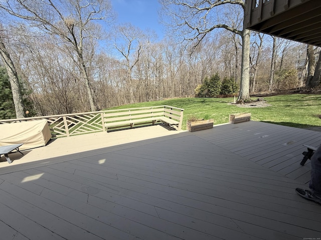 wooden deck with a lawn