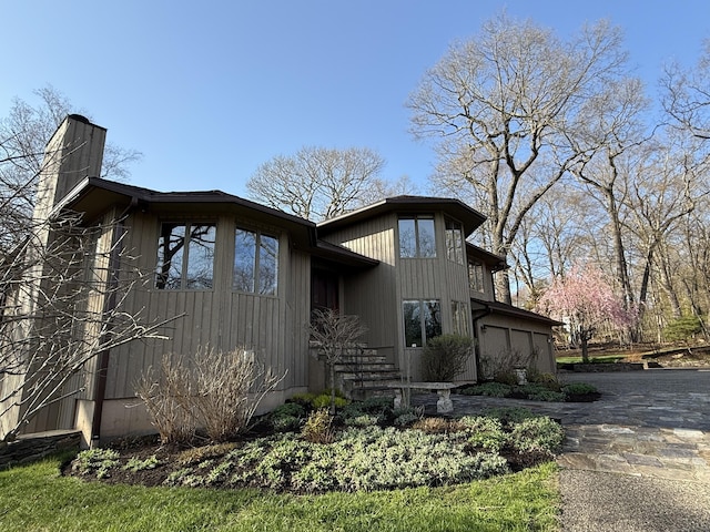 view of side of home featuring a chimney