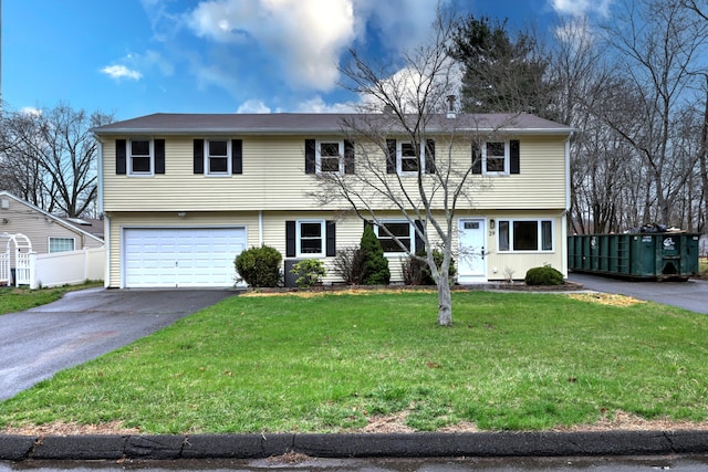view of front of property featuring asphalt driveway and an attached garage