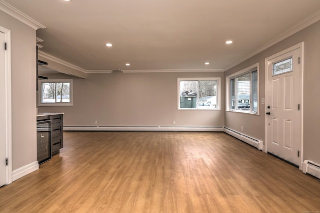 unfurnished living room with wood finished floors, healthy amount of natural light, crown molding, recessed lighting, and baseboards