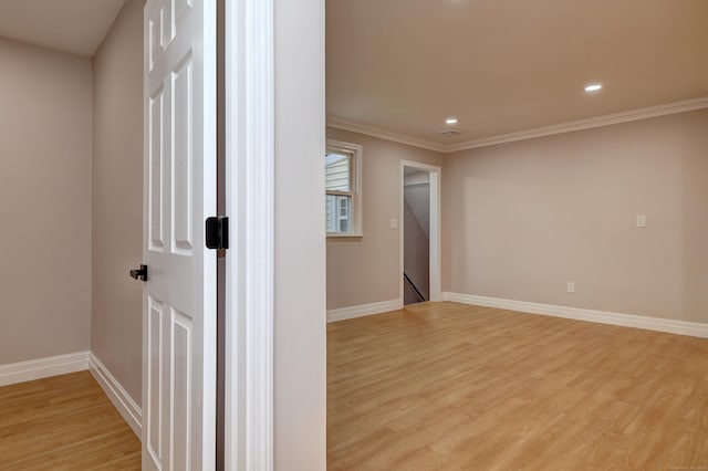 spare room with light wood-style flooring, baseboards, recessed lighting, and ornamental molding
