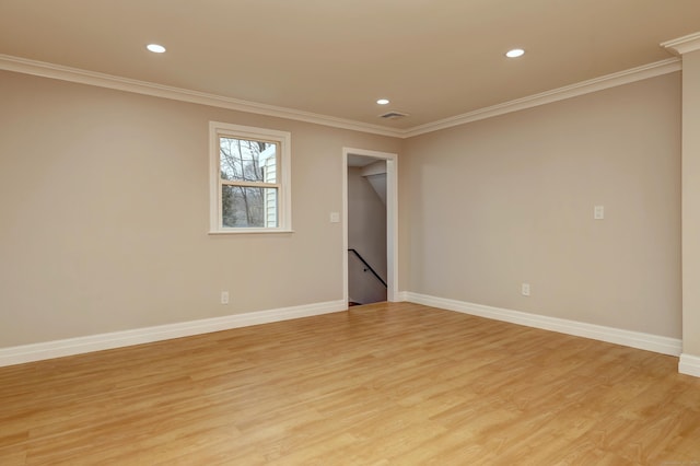 empty room with baseboards, recessed lighting, ornamental molding, and light wood-style floors
