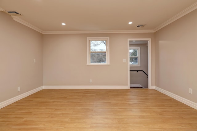 empty room featuring recessed lighting, crown molding, light wood-type flooring, and baseboards