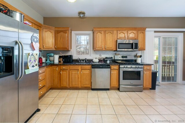 82 Summer St Unit A, Southington, CT 06489 - kitchen with a sink, tasteful backsplash, appliances with stainless steel finishes, and brown cabinets