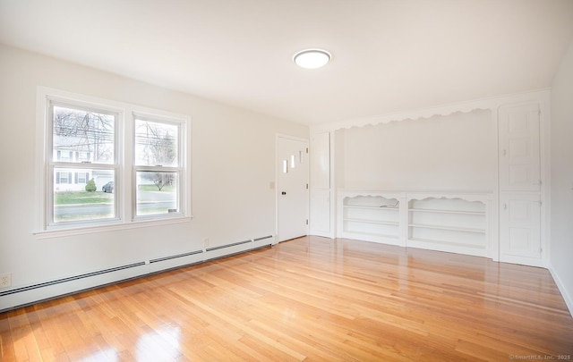 interior space featuring wood finished floors and baseboard heating