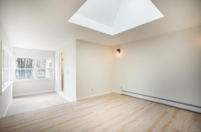 unfurnished room with baseboards, a baseboard radiator, and wood finished floors