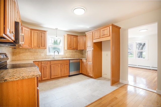 kitchen with decorative backsplash, hanging light fixtures, baseboard heating, stainless steel dishwasher, and a sink