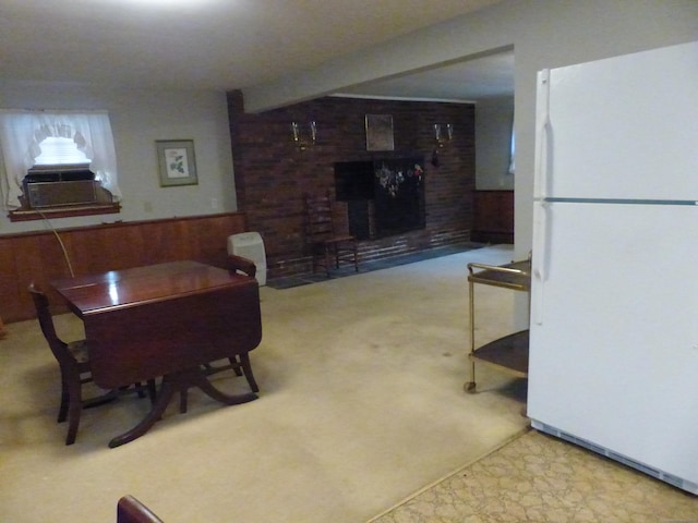 48 Renshaw Rd, Hamden, CT 06518 - carpeted dining space with a brick fireplace, wood walls, cooling unit, and a wainscoted wall