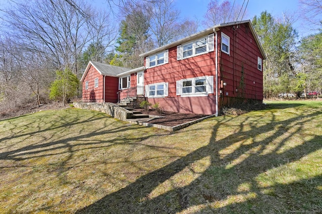 rear view of house featuring a yard