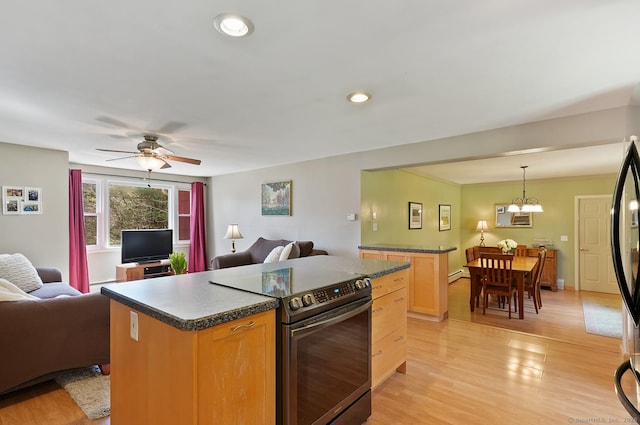 kitchen with stainless steel electric range oven, open floor plan, dark countertops, light wood-style floors, and recessed lighting