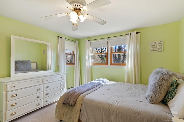 bedroom featuring a ceiling fan and carpet