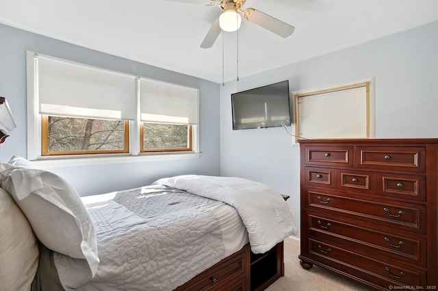 bedroom with light carpet and a ceiling fan