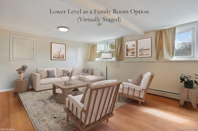 living room with light wood-style flooring, a baseboard radiator, baseboards, and beam ceiling