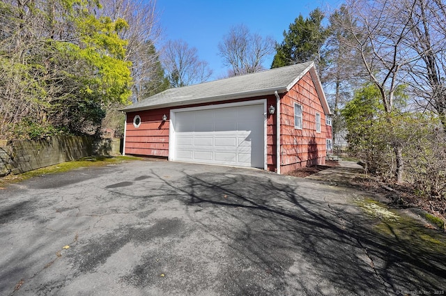 detached garage featuring fence