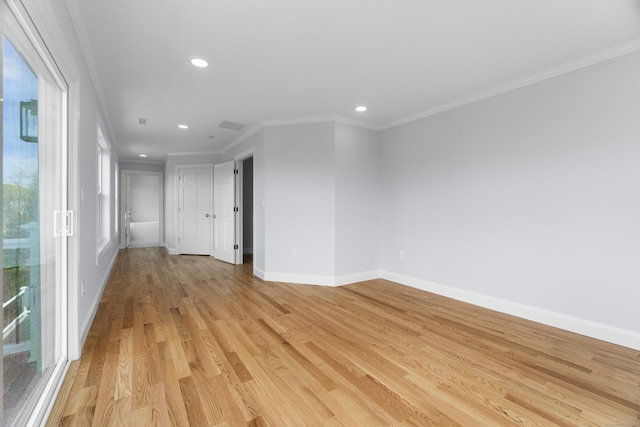 empty room featuring ornamental molding, baseboards, light wood-type flooring, and recessed lighting